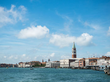 View of buildings by canal against sky in venice, italy