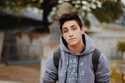 Portrait of young man standing outdoors