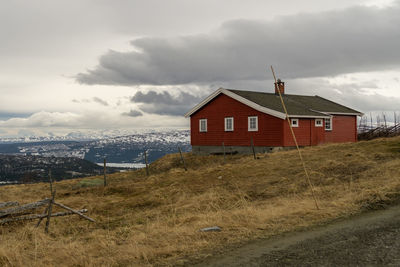 House on field against sky