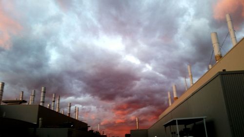 Low angle view of storm clouds over city