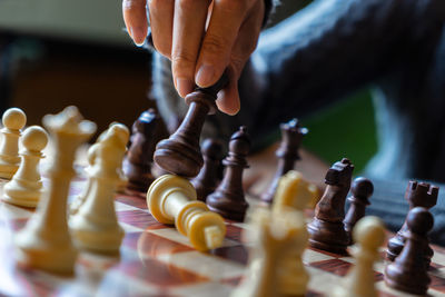 Midsection of man playing with chess