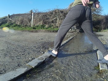 Woman standing on footpath