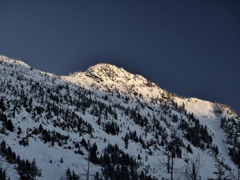 Scenic view of snowcapped mountains against clear sky