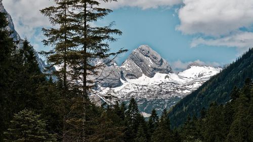 Low angle view of snowcapped mountains against sky