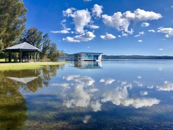 Scenic view of lake by building against sky