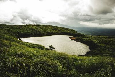 Scenic view of landscape against cloudy sky