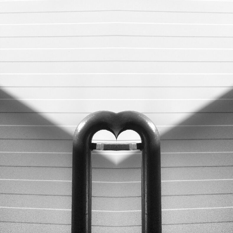 CLOSE-UP OF HEART SHAPE ON METAL STRUCTURE