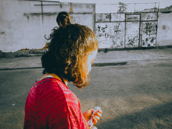 Side view of woman standing on road