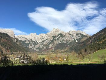 Scenic view of mountains against cloudy sky