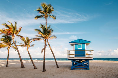 Lifeguard hut on beach against sky