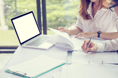 Woman using laptop on table