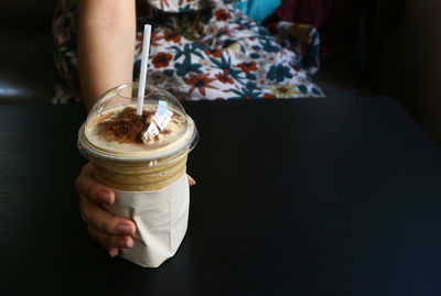 Midsection of person holding coffee cup