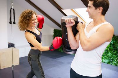 Young woman exercising in gym