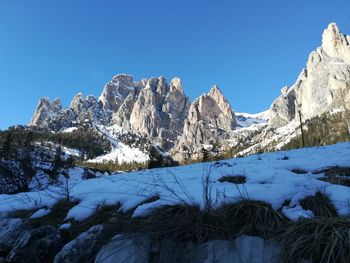 Scenic view of snowcapped mountains against clear blue sky