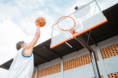 Low angle view of basketball hoop against sky