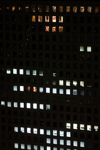 Low angle view of illuminated skyscraper at night