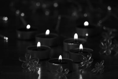 Close-up of lit candles on table