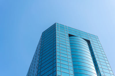 Low angle view of modern building against clear blue sky