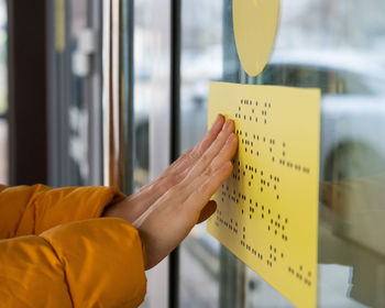 Cropped hand of woman holding book