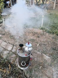 High angle view of man cooking on barbecue grill