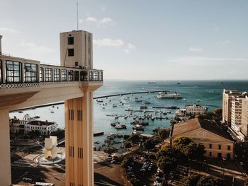 High angle view of buildings by sea against sky