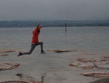 Woman on beach against sky