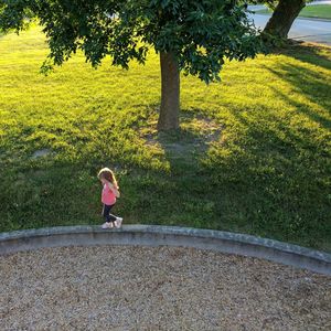 High angle view of girl walking at park