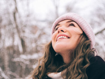 Smiling young woman looking up