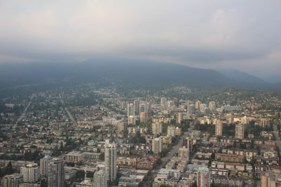 High angle view of illuminated city buildings against sky