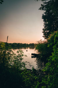 Scenic view of lake against sky at sunset