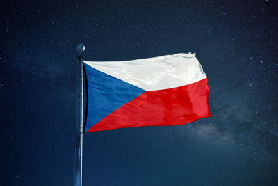 Low angle view of flag against sky at night