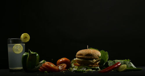 Close-up of fruits on table against black background