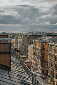 High angle view of buildings by street against sky