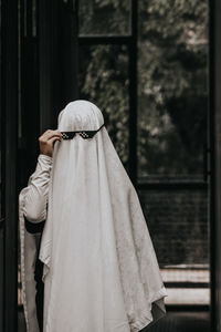 Woman wearing blanket standing outdoors