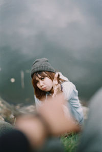 Portrait of young woman wearing hat