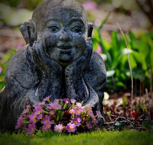 Close-up of buddha statue in park