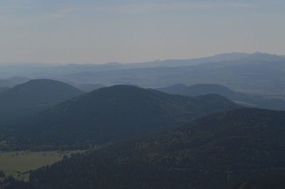 Scenic view of mountains against cloudy sky