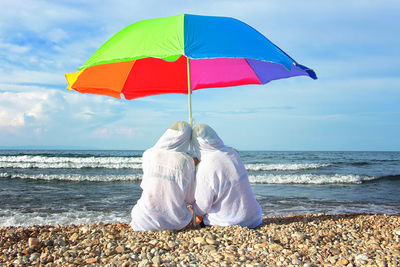 Rear view of umbrella on beach