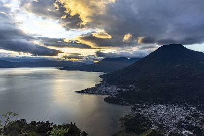 Aerial view of sea and mountains against sky