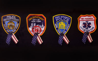 Close-up of badges against black background