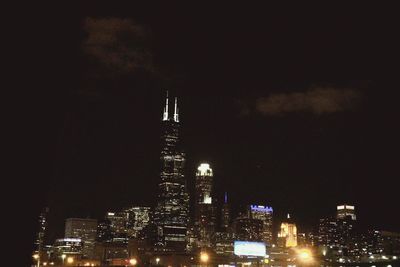 Low angle view of city lit up at night