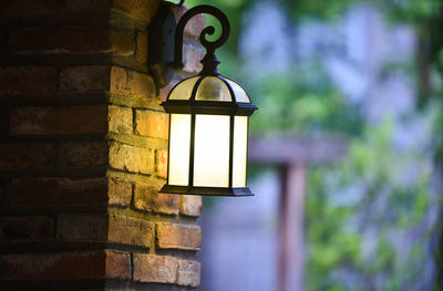 Close-up of illuminated lamp on wall