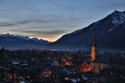 Aerial view of houses and mountains during winter at night