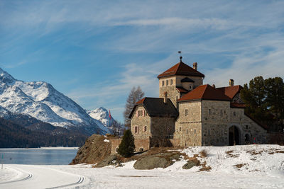 Silvaplana,switzerland, february 21, 2023 historic old castle crap da sass at the lake of silvaplana 