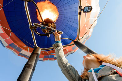 Low angle view of woman in hot air balloon