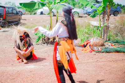 People wearing costumes performing on land