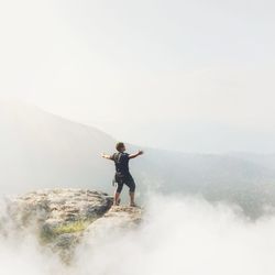 Full length of man standing on mountain against sky