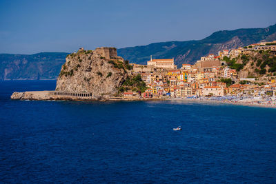 Scenic view of sea and buildings against sky