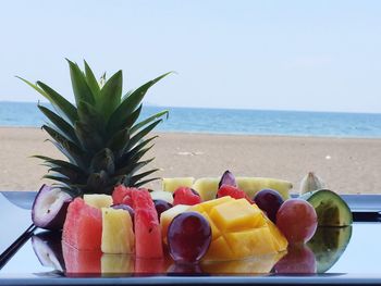 Close-up of fruit salad served on beach