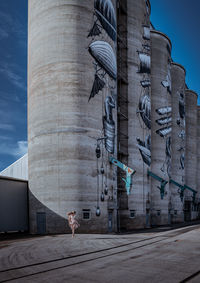 Woman against buildings in city